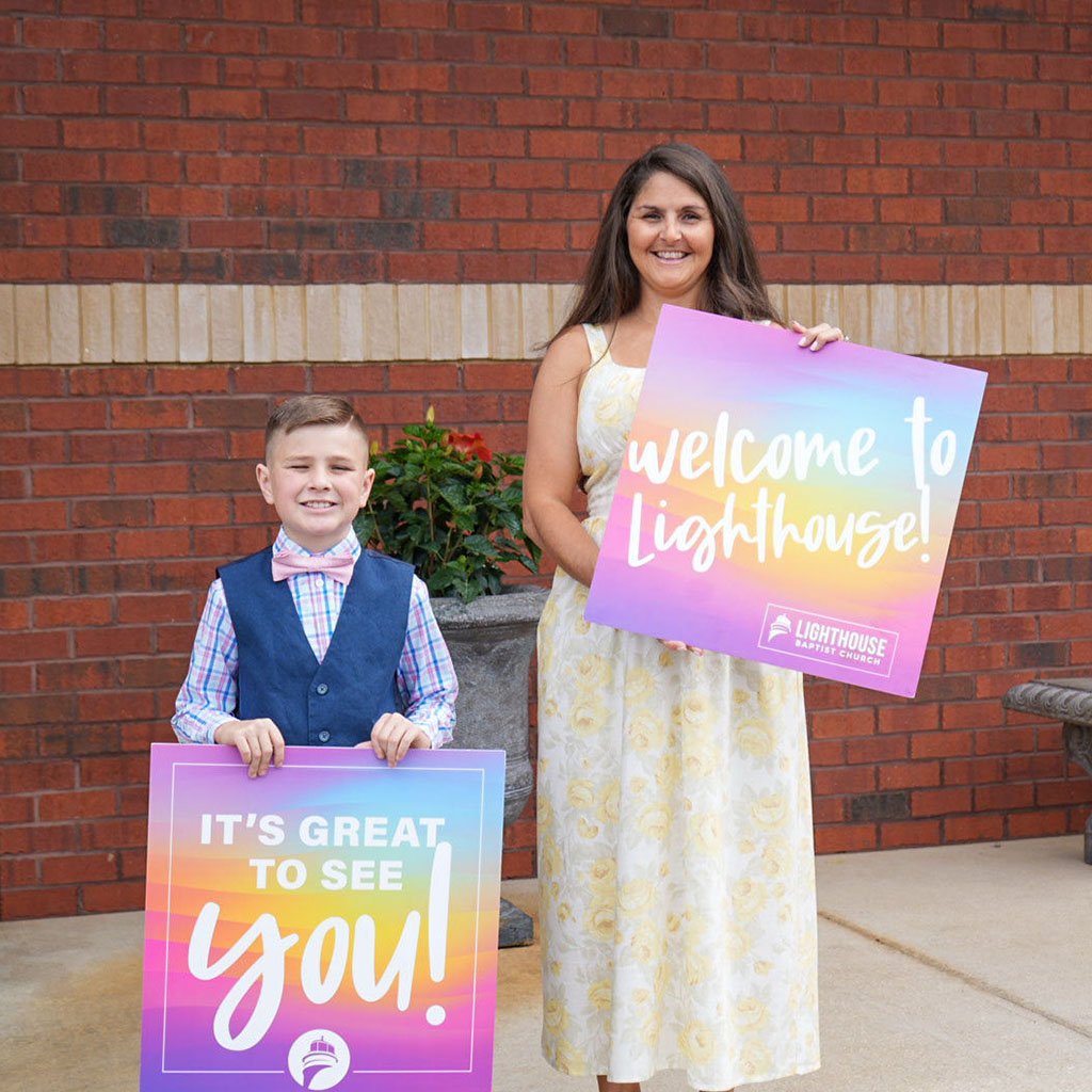 Image of two greeters welcoming visitors to Lighthouse Baptist Church in Theodore, AL.